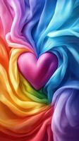 Colorful heart surrounded by flowing silk fabric in vibrant rainbow hues photo