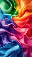 Vibrant silk fabric displaying a spectrum of colors in wavy layers with soft textures photo