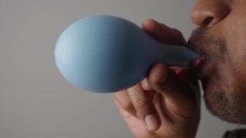 Creating sound with a blue instrument in a close-up view video