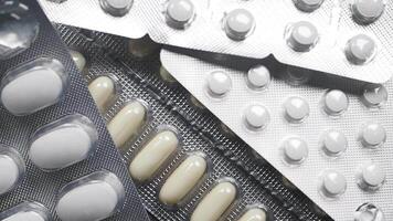 Medicines displayed on a surface in various packaging and colors video