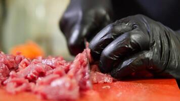 Cooking demonstration of meat preparation techniques with gloves video