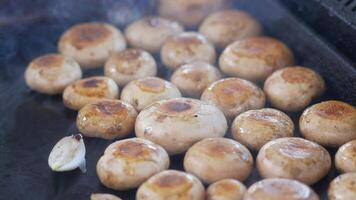 Grilling fresh mushrooms on a hot grill in a backyard setting video