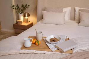 Tray with breakfast on bed photo