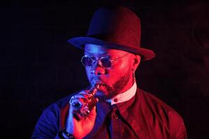 Stylish black man with vaping mod photo