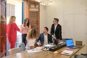 Group of colleagues discussing business in office photo