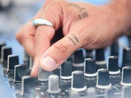 Crop DJ adjusting sound of music photo