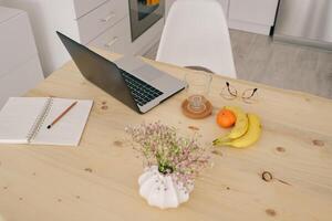 Workplace with laptop in dining room photo