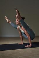 Positive sportswoman taking Firefly pose in studio photo