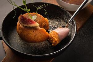 Appetizing dessert decorated with piece of fig served on pan photo