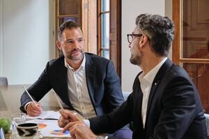 Colleagues looking to each other in office photo