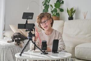 Boy pointing up and talking while shooting at home photo
