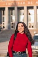Student woman portrait smiling and posing while looking at the camera photo