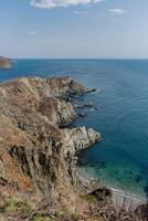 View of the vastness of the Pacific Ocean from the high seashore. High cliffs photo