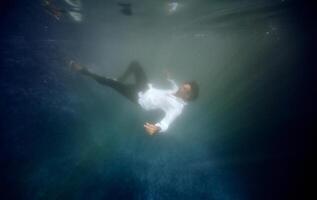 Man drowning in swimming pool photo
