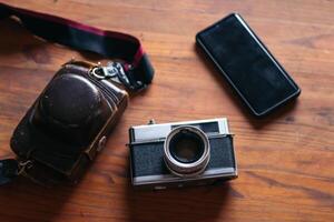 Analog camera and smartphone old and new technology. photo