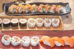 Delicious set of assorted sushi rolls served in row photo