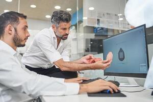 Engineers designing face mask on computer photo