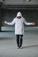 Man standing in garage with arms apart photo
