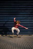 Energetic boy riding skateboard on sidewalk photo