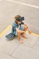 Boy in VR headset sitting on skateboard photo