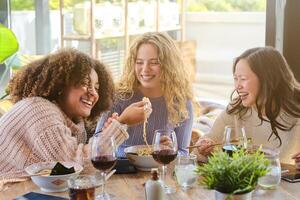 Laughing friends having fun in restaurant photo