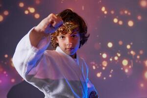 Boy in kimono practicing martial art photo