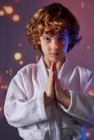 Boy in kimono doing greeting gesture photo