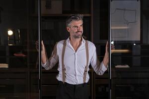 Smiling man standing between sliding doors photo