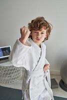 Boy practicing defense blocks at home photo