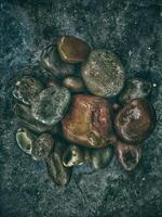 Rocks and pebbles on a concrete surface photo