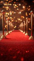 Elegant red carpet pathway lined with stanchions and sparkling lights creating a celebratory atmosphere photo