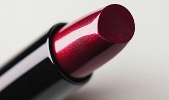 a close up of a red lipstick on a white surface photo