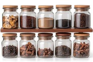 Glass jars with wooden lids containing various spices resting on a wooden shelf photo