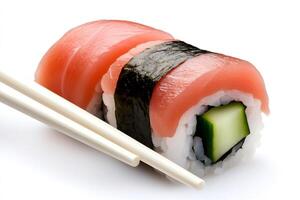 Chopsticks picking up delicious tuna and cucumber maki sushi roll photo