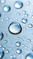 Macro water drops creating a beautiful pattern on a light blue background photo