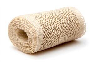 Beige mesh ribbon roll resting on white background photo