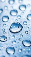 Close-up of water droplets forming unique patterns on a blue surface photo