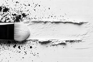 Artistic Brushstroke with Black Pigment and Textured White Paint on Canvas photo