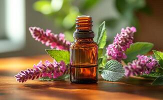 A bottle of essential oil is on a table next to some purple flowers. The bottle is brown and has a green label. The flowers are purple and are arranged in a way that they are not touching the bottle photo
