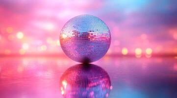 Colorful disco ball shining. A disco ball glistens under colorful lights, casting bright reflections on a smooth surface during a lively atmosphere. photo