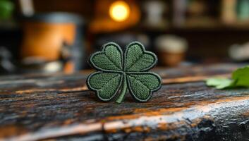 Green shamrock patch on wooden table. A green shamrock patch rests on a rustic wooden table in a cozy indoor setting, capturing an autumnal atmosphere. photo