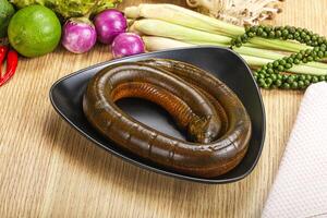 A plate with a worm on it next to some vegetables photo