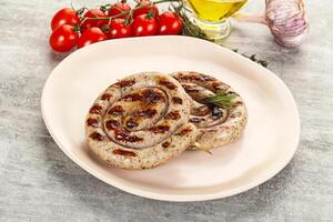A plate with two grilled sausages on it photo