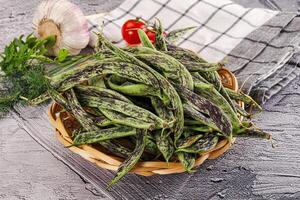 A basket filled with green beans and garlic photo