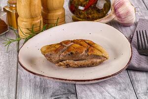 A plate of food on a table with a knife and fork photo