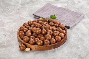 A bowl of nuts on a table with a napkin photo