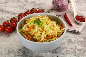 A bowl of coleslaw with tomatoes and onions photo