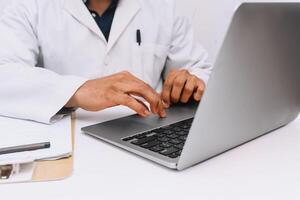 Hands of health personal with a laptop on a desk with a laptop. communication and medical technology concept. photo