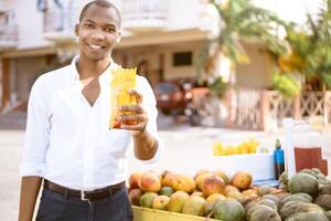 portrait of a happy smiling african american casual trader man holding a bag with cut handles photo