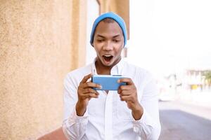 Man with face amazement while go and hold your mobile phone. online applications and games concept photo